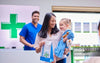 Mother and daughter carrying prescription from pharmacist in paper bag