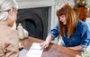 Lady patient pointing at booklet on the table between her and Dr Megan Rossi