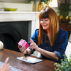 Patient holding and reading pack of SMART STRAINS for your vaginal microbiome